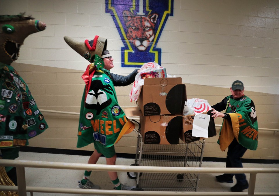 <strong>Paul Fermi (right) and Van Raby with the Secret Order of Boll Weevils deliver boxes of presents to Vollentine students on Thursday, Dec. 19.</strong> (Jim Weber/Daily Memphian)