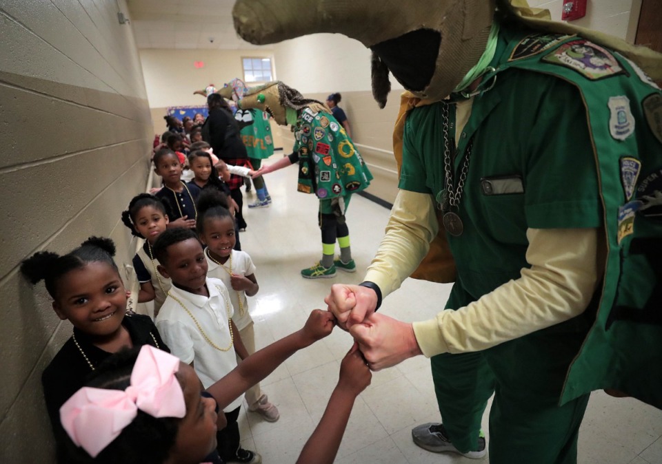 <strong>Members of the Boll Weevils keep students entertained as the Shelby County Sheriff's Office delivers Angel Tree gifts at Vollentine on Thursday, Dec. 19.</strong> (Jim Weber/Daily Memphian)