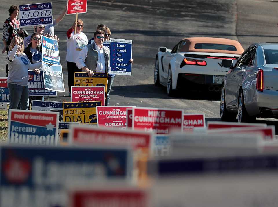 <strong>Candidates and volunteers wave at voters as they enter the First Baptist Church polling location in Lakeland on Election Day, Nov. 6.</strong> (Jim Weber/Daily Memphian)