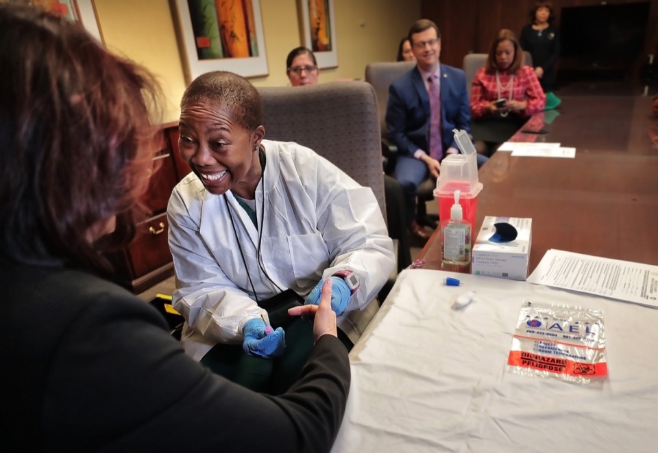 <strong>At the Shelby County Health Department, Public Health Nurse Cornelia Bobo conducts a demonstration Dec. 19 of the lead screening process that will be used on students at the SCS schools where elevated lead samples were found in the water.</strong> (Jim Weber/Daily Memphian)