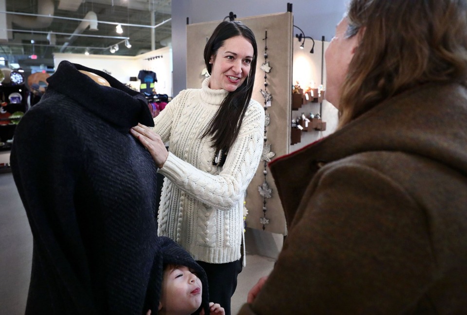 <strong>Coraline Kelly (left, with son Connor) talks to designer Elizabeth Holliday while shopping at the WinterArts collection in East Memphis on Thursday, Dec. 19.</strong> (Patrick Lantrip/Daily Memphian)