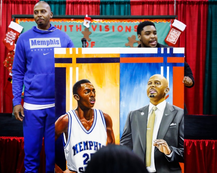 <strong>University of Memphis head basketball coach Penny Hardaway (left) received a painting of himself from local artist Micheal Wilkins (right) during the Tigers' toy giveaway on Dec. 20, 2019, at the Davis Community Center.</strong> (Mark Weber/Daily Memphian)