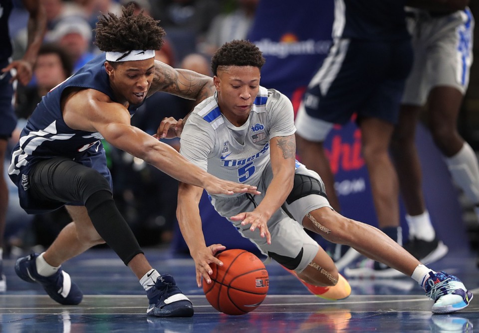 <strong>University of Memphis guard Boogie Ellis (5) scrambles for a loose ball with Jackson State's Venji Wallis during the Tigers' game on Dec. 21, 2019, against JSU at the FedExForum.</strong> (Jim Weber/Daily Memphian)