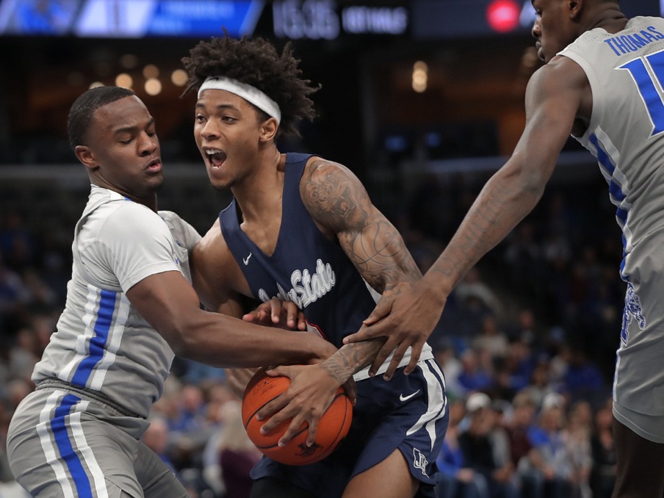 <strong>University of Memphis guard Alex Lomax (left) tries to make a steal against Jackson State's Venji Wallis during the Tigers' game on Dec. 21, 2019, against JSU at the FedExForum.</strong> (Jim Weber/Daily Memphian)