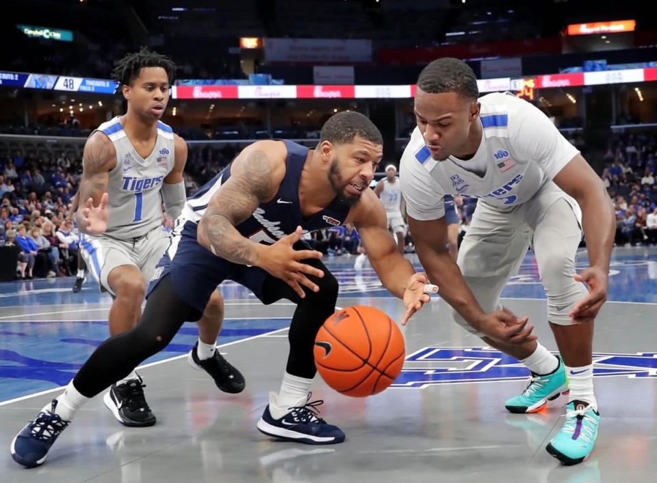<strong>University of Memphis guard Alex Lomax (right) steals the ball from Jackson State's Dontelius Ross during the Tigers' game on Dec. 21, 2019, against JSU at the FedExForum.</strong> (Jim Weber/Daily Memphian)