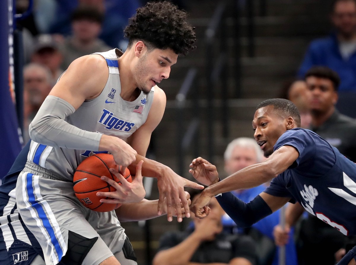 <strong>University of Memphis forward Isaiah Maurice (left) scrambles for a loose ball with Jackson State's Jonas James (right) during the Tigers' game on Dec. 21, 2019, against JSU at the FedExForum.</strong> (Jim Weber/Daily Memphian)