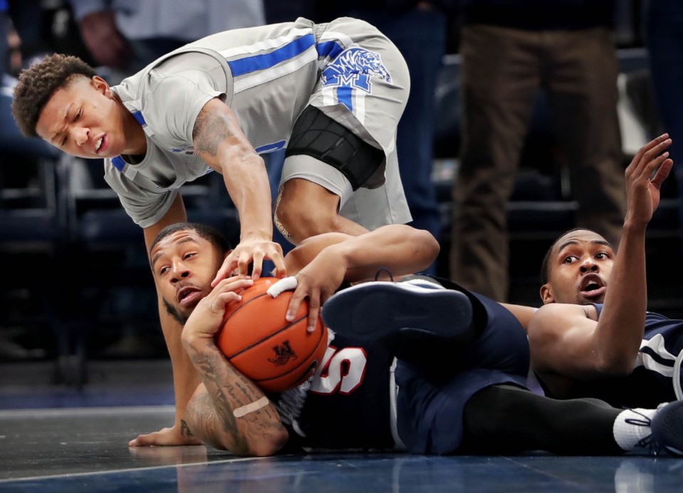 <strong>University of Memphis guard Boogie Ellis (left) scrambles for a loose ball with Jackson State's Dontelius Ross (5) during the Tigers' game on Dec. 21, 2019, against JSU at the FedExForum.</strong> (Jim Weber/Daily Memphian)