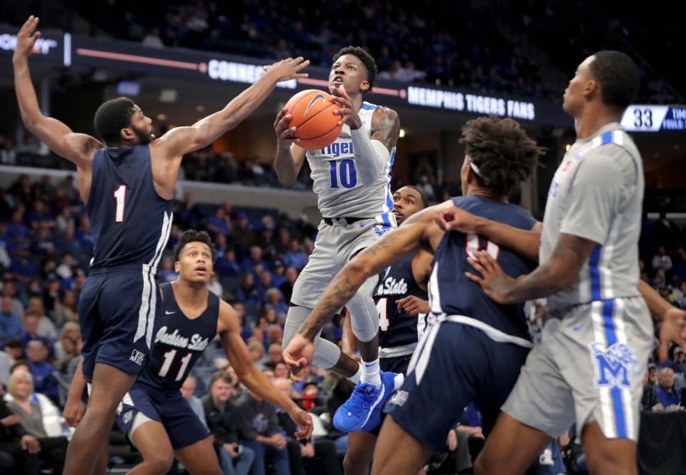 <strong>University of Memphis guard Damion Baugh (10) shoots under pressure by Jackson State's Roland Griffin (1) during the Tigers' game on Dec. 21, 2019, against JSU at the FedExForum.</strong> (Jim Weber/Daily Memphian)