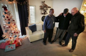 <strong>MIFA volunteers Phil Taylor (right) and Bill Craddock pray with friend and client Willie C. (left) after delivering a meal and a Christmas carol on Dec. 10, 2019.&nbsp;</strong> (Jim Weber/Daily Memphian)