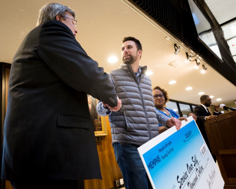 <strong>Mayor Jim Strickland awards Paul Walkley of Service Over Self a grant for $60,000 from the first City Housing Trust at City Hall on Mon., Dec. 23, 2019.</strong> (Ziggy Tucker/Special to the Daily Memphian)