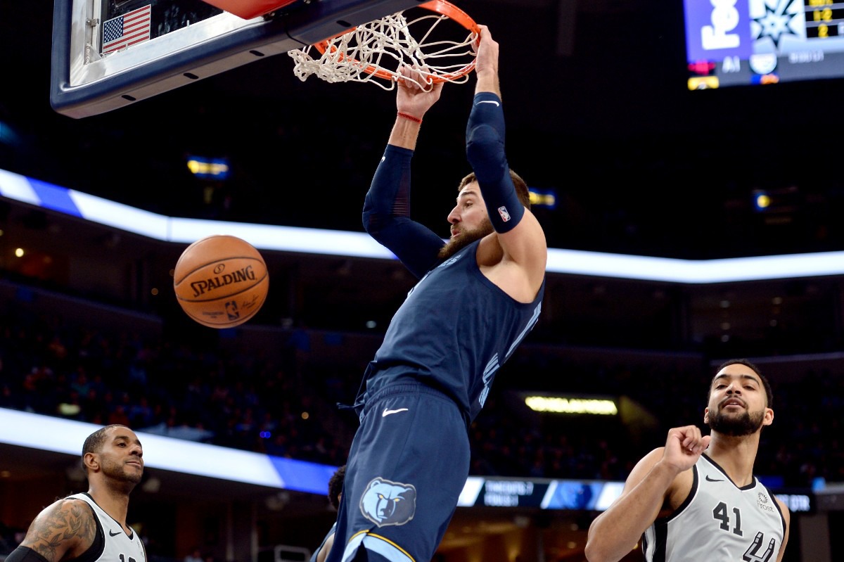 <strong>Memphis Grizzlies center Jonas Valanciunas dunks between San Antonio Spurs center LaMarcus Aldridge, left, and forward Trey Lyles (41)</strong>&nbsp;<strong>Dec. 23 at FedExForum.</strong> (Brandon Dill/AP)