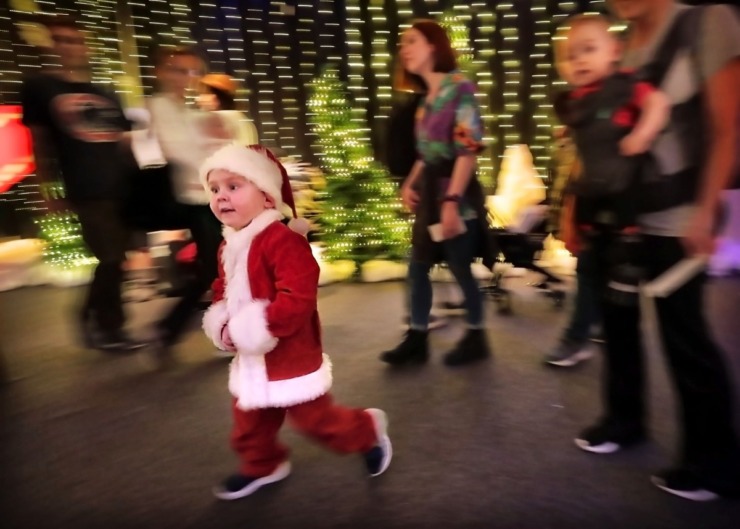 <strong>Chase Williamson (left) wanders through the lights decked out in Christmas finery during a visit to the Enchanted Forest at the Pink Palace on Dec. 24, 2019.&nbsp;</strong><strong>The&nbsp;Enchanted Forest has been a holiday attraction in Memphis for more than 50 years, beginning its life in Goldsmith's Department Store with some of the same animatronic characters which still reside in the exhibit.</strong> (Jim Weber/Daily Memphian)