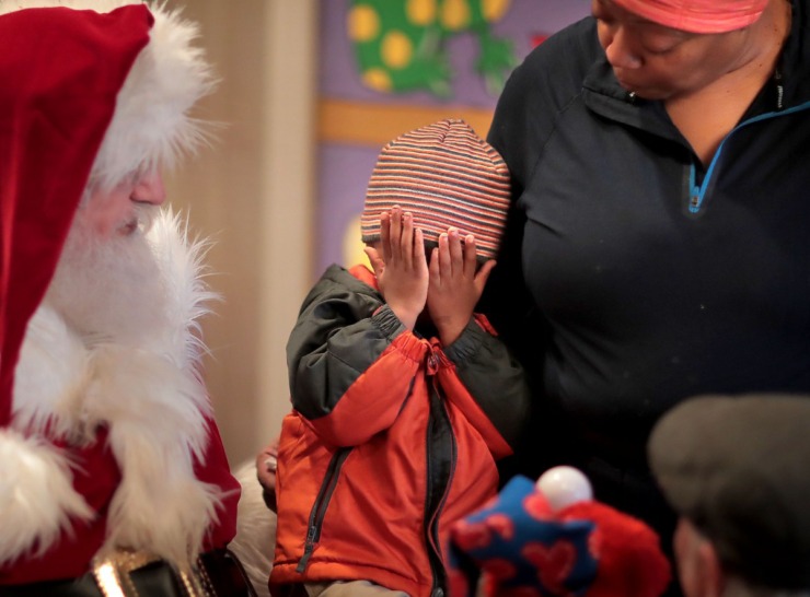 <strong>T.J. Buchanan, 2, gets a little bashful while visiting Santa, played by Charles Bohannon, during a trip to the Enchanted Forest at the Pink Palace on Dec. 24, 2019. The Enchanted Forest has been a holiday attraction in Memphis for more than 50 years, beginning its life in Goldsmith's Department Store with some of the same animatronic characters which still reside in the exhibit.&nbsp;</strong>(Jim Weber/Daily Memphian)