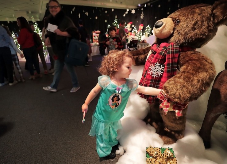 <strong>Isabella Miller shakes hands with a Christmas bear during a visit to the Enchanted Forest exhibit at the Pink Palace on Dec. 24, 2019. The Enchanted Forest has been a holiday attraction in Memphis for more than 50 years, beginning its life in Goldsmith's Department Store with some of the same animatronic characters which still reside in the exhibit.&nbsp;</strong>(Jim Weber/Daily Memphian)