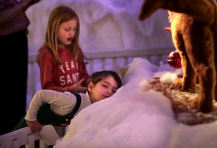 <strong>The snow might not be very cold, but one young visitor discovers that it is soft at the Enchanted Forest exhibit at the Pink Palace on Dec. 24, 2019. The Enchanted Forest has been a holiday attraction in Memphis for more than 50 years, beginning its life in Goldsmith's Department Store with some of the same animatronic characters which still reside in the exhibit.&nbsp;</strong>(Jim Weber/Daily Memphian)
