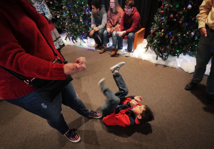 <strong>Andrew MacDermant, 7, tries several ploys to avoid leaving the Enchanted Forest, but his mother Hope MacDermant (left) isn't buying it during a visit the Pink Palace on Dec. 24, 2019. The Enchanted Forest has been a holiday attraction in Memphis for more than 50 years, beginning its life in Goldsmith's Department Store with some of the same animatronic characters which still reside in the exhibit.&nbsp;</strong>(Jim Weber/Daily Memphian)