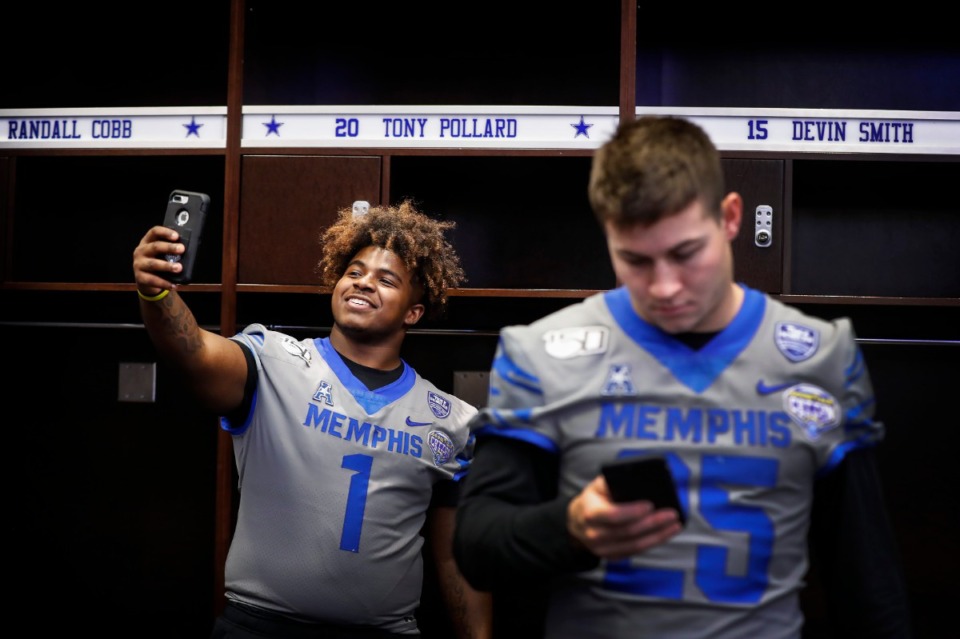 <strong>University of Memphis defensive lineman O'Bryan Goodson (left) takes a selfie at the locker of former teammate and current Dallas Cowboy player Tony Pollard during the Cotton Bowl Media Day on Dec. 26, 2019, at AT&amp;T Stadium in Arlington, Texas.</strong> (Mark Weber/Daily Memphian)