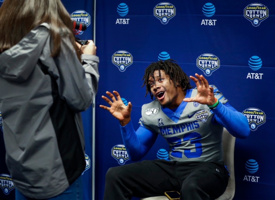 <strong>University of Memphis linebacker JJ Russell (right) roars for the camera during a breakout session at the Cotton Bowl Media Day on Dec. 26, 2019, at AT&amp;T Stadium in Arlington, Texas.</strong> (Mark Weber/Daily Memphian)