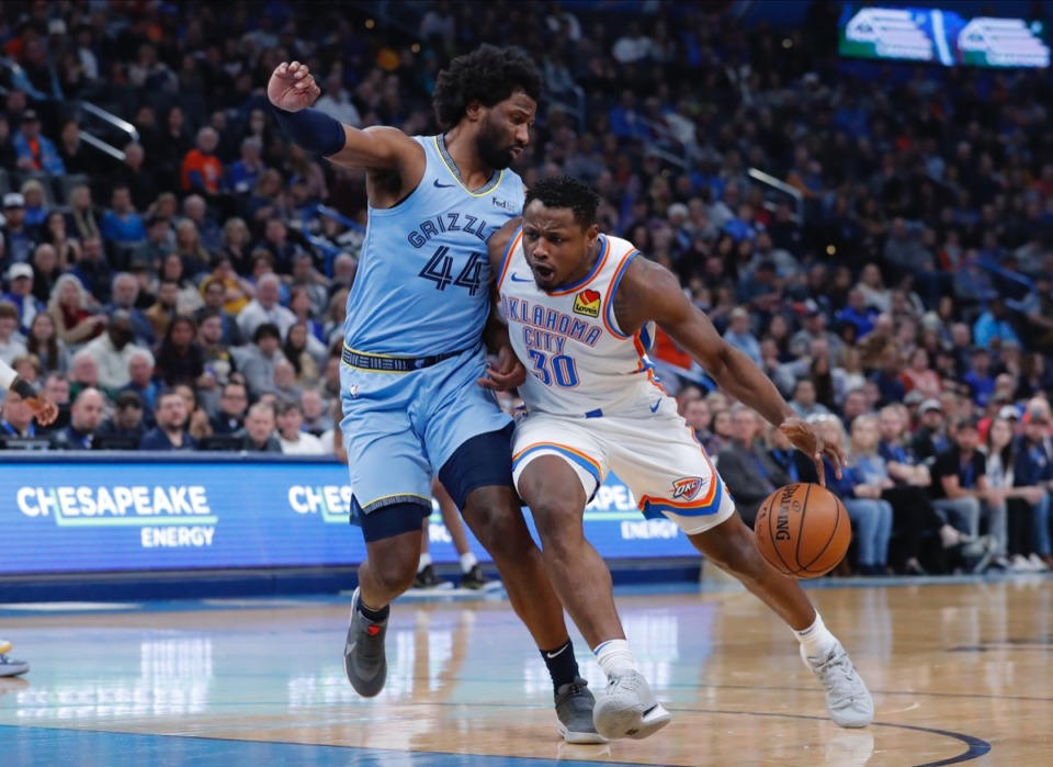 <strong>Grizzlies forward Solomon Hill (44) &nbsp;tries to block Oklahoma City Thunder guard Deonte Burton (30) from the basket Dec. 26 in Oklahoma City.</strong> (Alonzo Adams/AP)