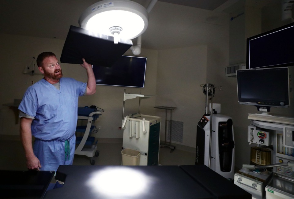 <strong>Steris sales representative David Lee tests out the shadow-eliminating surgical lights he's installing in Campbell Clinic's new state-of-the-art Germantown campus on Dec. 18, 2019.</strong> (Patrick Lantrip/Daily Memphian)