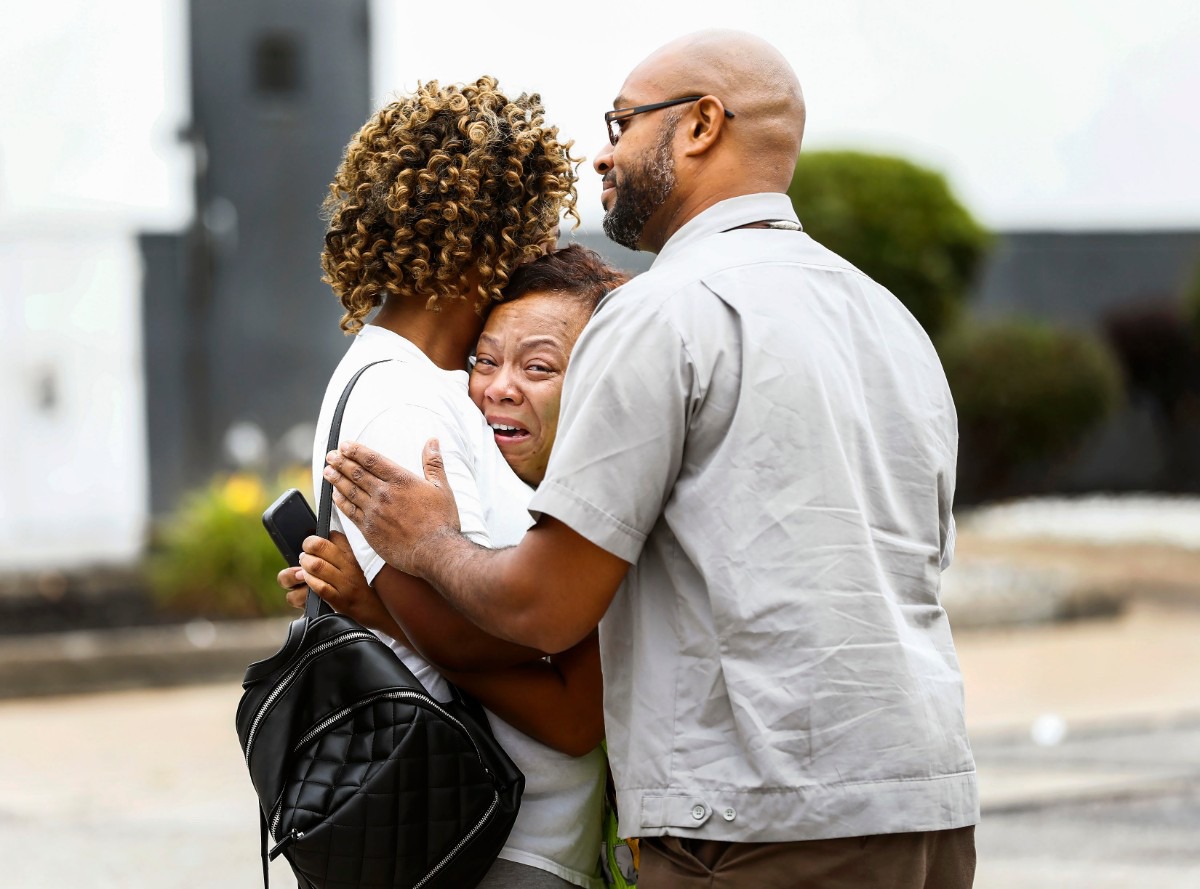 <strong>Two people offer comfort to an unidentified woman who was overheard saying "That's my best friend" in the aftermath of a shooting at the Walmart store in Southaven, Miss., on July 30, 2019. Two people were killed and the suspect and a police officer were injured during the early-morning shooting.</strong> (Mark Weber/Daily Memphian)