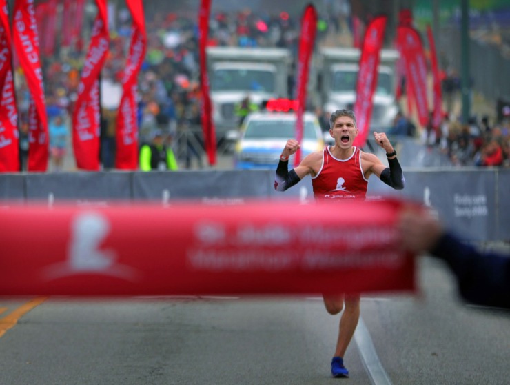 <strong>Adam Higham celebrates as he races down the stretch on his way to a first-place finish at the St. Jude Marathon in Downtown Memphis on Dec. 7, 2019.</strong> (Patrick Lantrip/Daily Memphian)