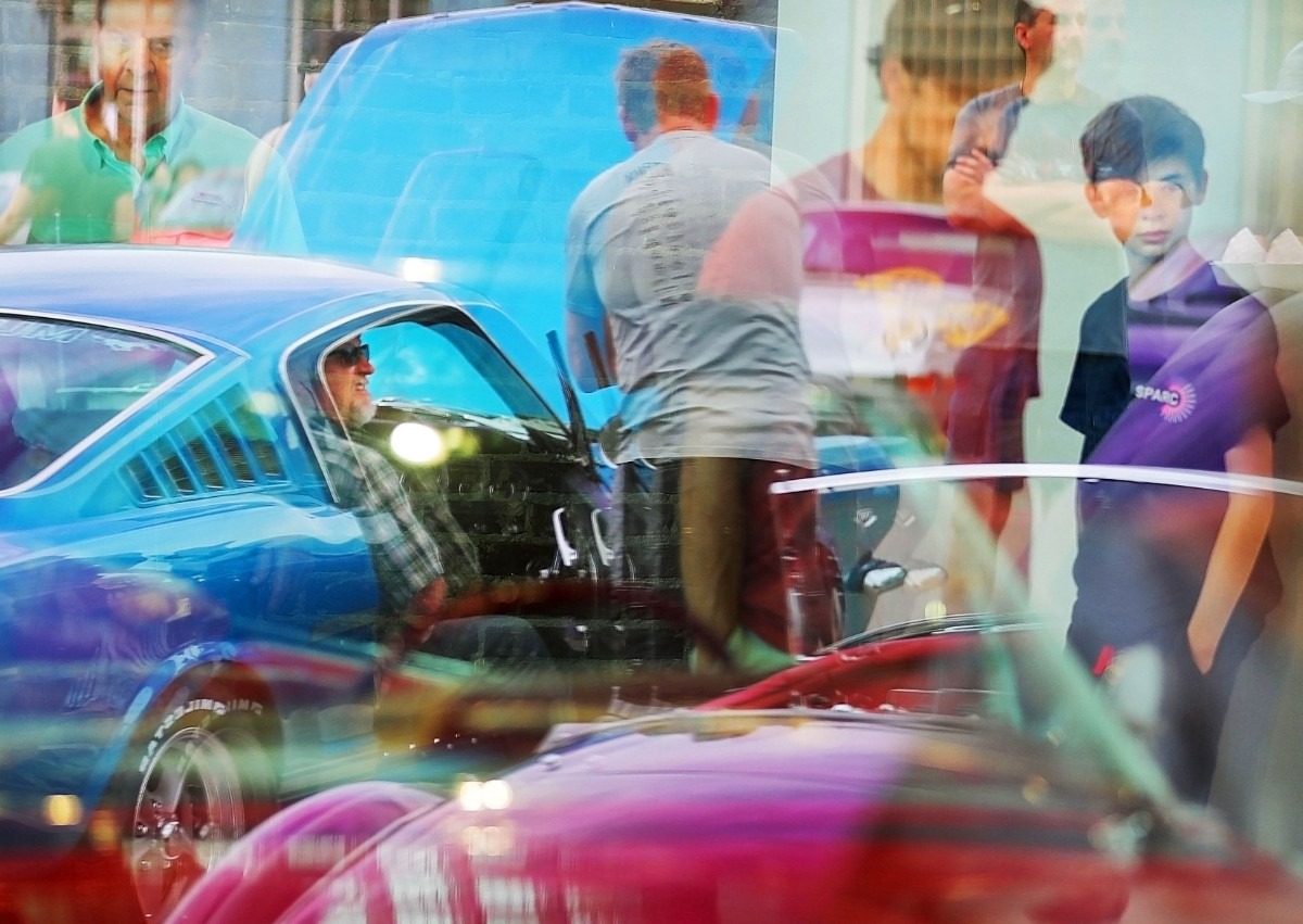 <strong>Chris Oswalt (center) and his son Jackson Oswalt, 14, check out a 1959 Cadillac on display during a block party to celebrate the opening of the Edge Automotive Museum on April 27, 2019, in the Edge District, an area with a rich history as a car repair and dealership district.</strong> (Jim Weber/Daily Memphian)
