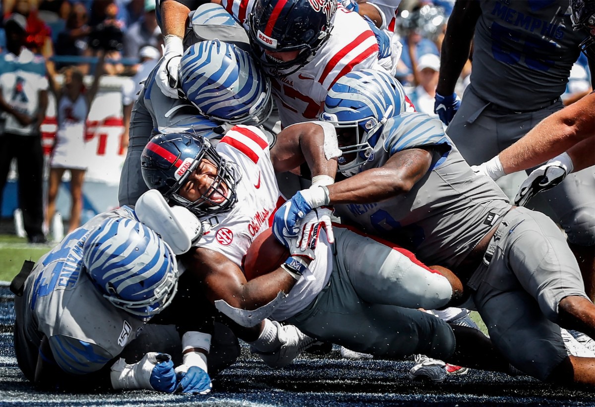 <strong>Ole Miss running back Scottie Phillips (middle) screams as he crosses the goal line for a touchdown against the Memphis defense during action in their NCAA game at the Liberty Bowl Memorial Stadium on Aug. 31, 2019.</strong> (Mark Weber/Daily Memphian)