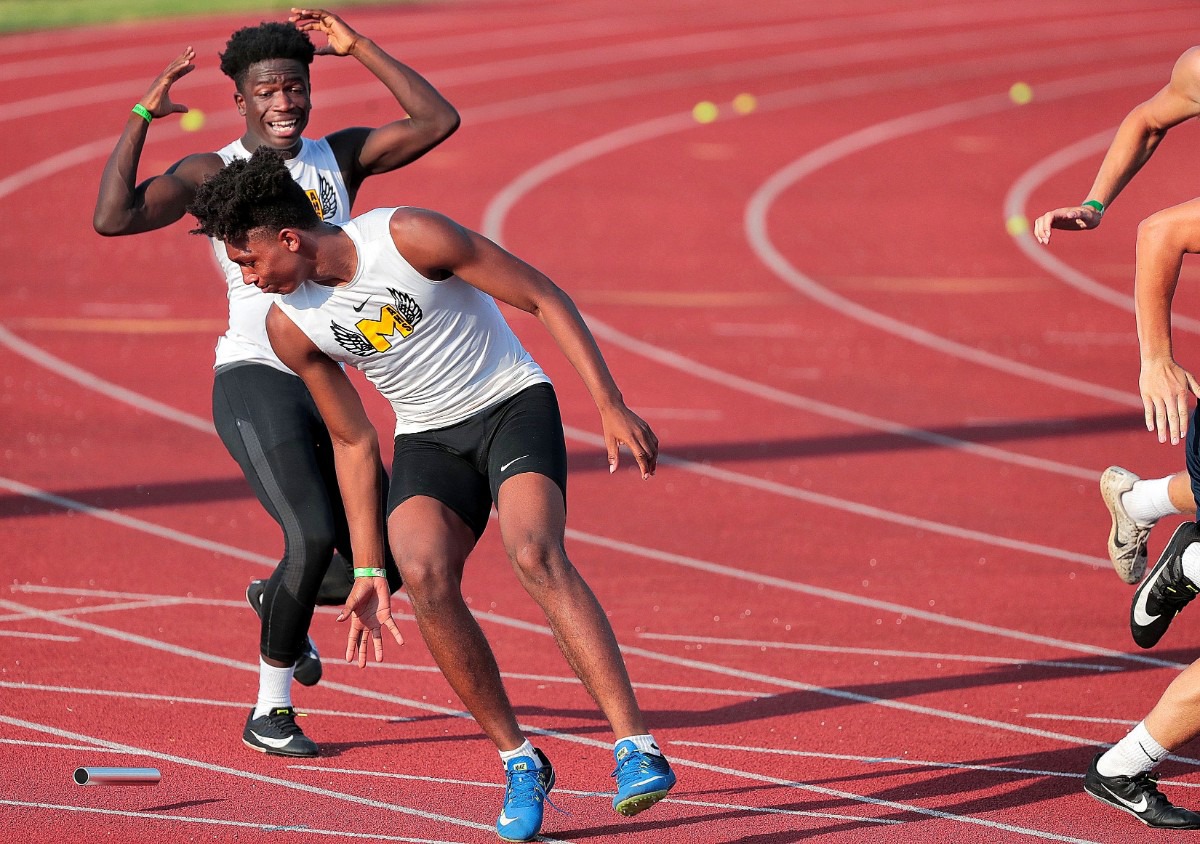 <strong>MASE 4X100M relay team members Cameron Bowles (left) and Sidney Hall struggle to get back on track after a juggled baton pass during the Spring Fling Class A-AA state track finals at MTSU in Murfreesboro on May 24, 2019.</strong> (Jim Weber/Daily Memphian)