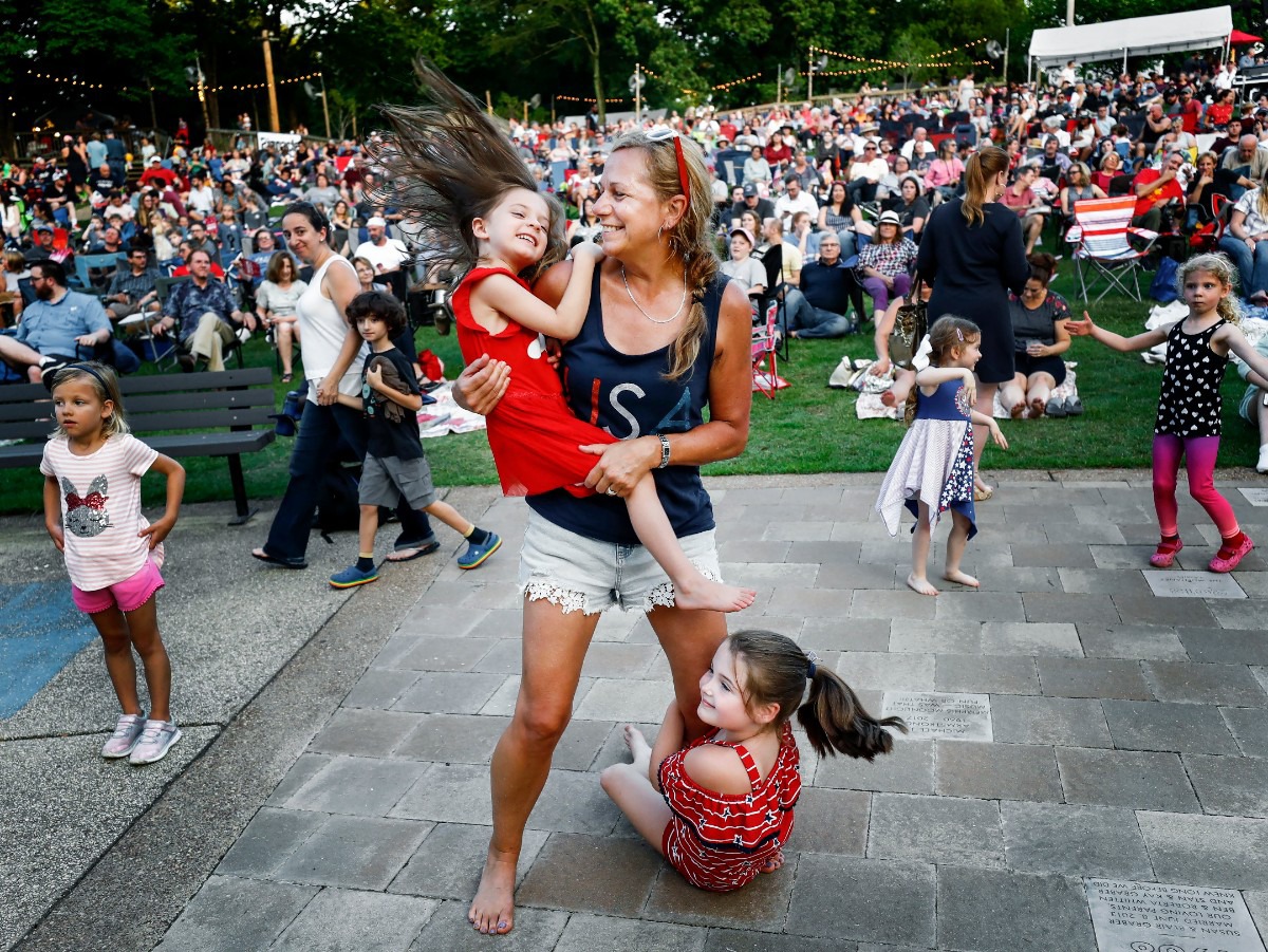 <strong>Holly Mosteller (middle) dances with her granddaughters Ava Price,4, (left) and Mallory Mosteller (right) during the Patriotic Pops with the Memphis Wind Symphony performance at the Levitt Shell on June 27, 2019.</strong> (Mark Weber/Daily Memphian)