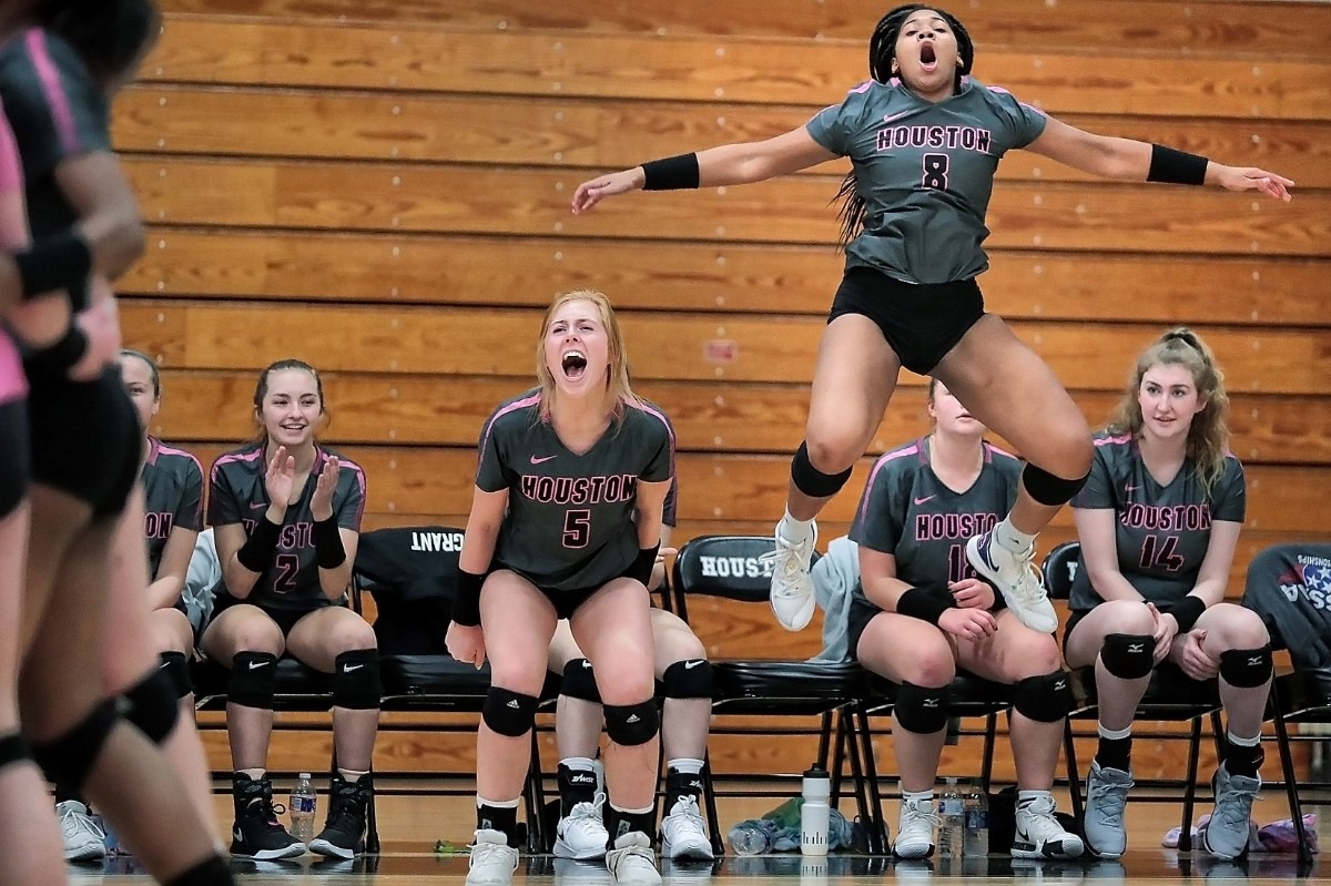 <strong>Houston teammates Brooke Grant (5) and Jordan Jones (8) celebrate a key point during Houston High School's regional finals volleyball win over Collierville at Houston on Oct. 15, 2019.</strong> (Jim Weber/Daily Memphian)