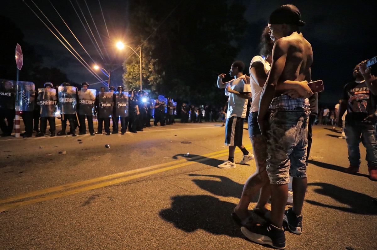 <strong>A man identified as Sonny Webber (right), father of Brandon Webber, who was reportedly shot by U.S. Marshals earlier in the evening, joins a standoff on June 12, 2019, as protesters take to the streets of Frayser in anger. Dozens of protesters clashed with police throwing stones and tree limbs until police forces broke the mob up with tear gas.</strong> (Jim Weber/Daily Memphian)