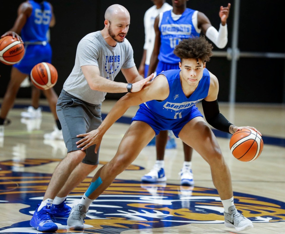 <strong>University of Memphis guard Lester Quinones (right), seen here working with assistant coach Cody Toppert Aug. 6, is returning after a hand injury. &ldquo;Getting Lester back gives us another hard worker and gives us another physical presence because he&rsquo;s very physical and plays the game really hard,&rdquo; coach Penny Hardaway said.</strong> (Mark Weber/Daily Memphian).
