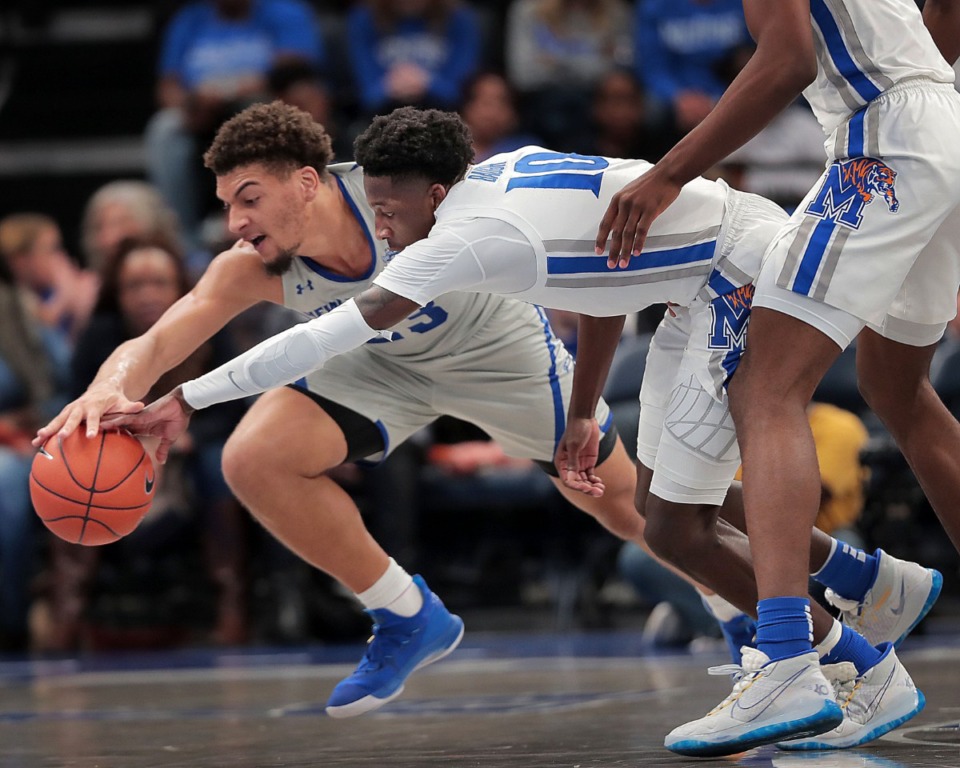 <strong>University of Memphis guard Damion Baugh scrambles for a loose ball with the Privateers' Ahren Freeman (left) during the Tigers' game on Dec. 28, 2019, against New Orleans at the FedExForum.</strong> (Jim Weber/Daily Memphian)