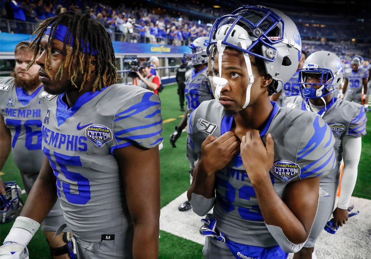 <strong>Dejected University of Memphis teammates Kameron Wilson (left) and Jashon Watkins-Perkins (right) walk off the field after losing to Penn State 53-39 in the Cotton Bowl on Dec. 28, 2019, at AT&amp;T Stadium in Arlington, Texas.</strong> (Mark Weber/Daily Memphian)