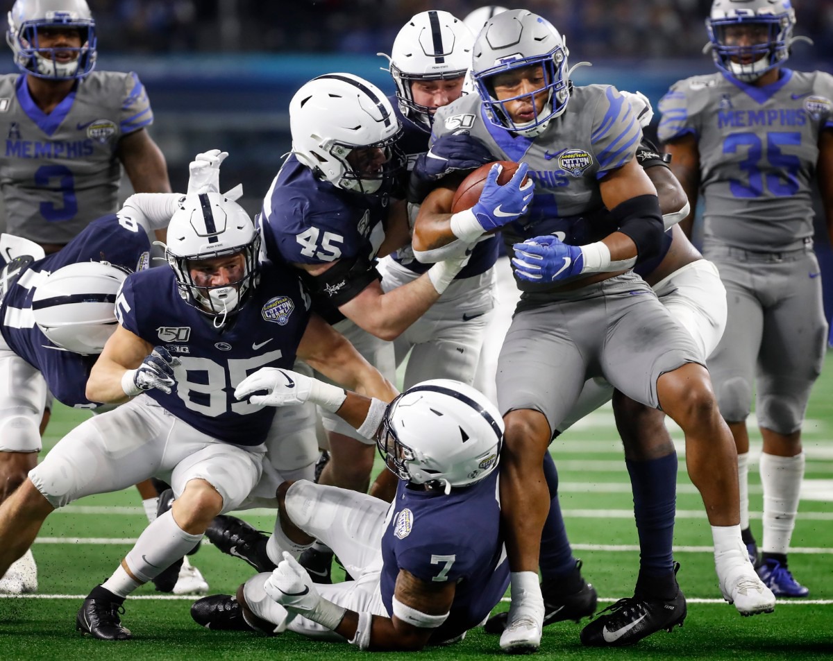 <strong>University of Memphis kick returner Antonio Gibson (right) is gang tackled by the Penn State defense during action at the Cotton Bowl on Dec. 28, 2019, at AT&amp;T Stadium in Arlington, Texas.</strong> (Mark Weber/Daily Memphian)