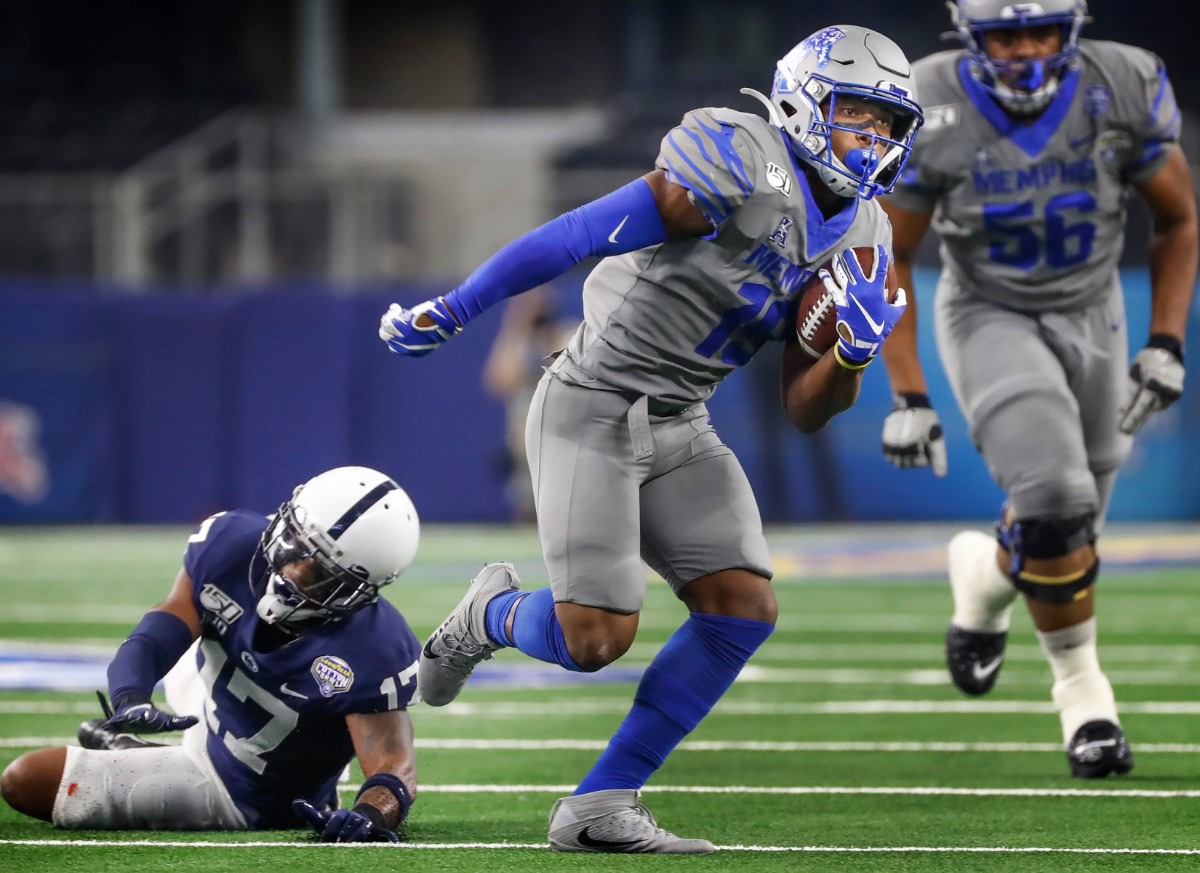 <strong>University of Memphis running back Kenneth Gainwell (right) runs for a first down past Penn State defender Garrett Taylor (left) during action at the Cotton Bowl on Dec. 28, 2019, at AT&amp;T Stadium in Arlington, Texas.</strong> (Mark Weber/Daily Memphian)