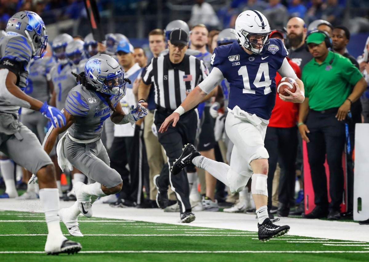 <strong>Penn State quarterback Sean Clifford (right) scrambles past the&nbsp;University of Memphis defense for a first down during action at the Cotton Bowl on Dec. 28, 2019, at AT&amp;T Stadium in Arlington, Texas.</strong> (Mark Weber/Daily Memphian)