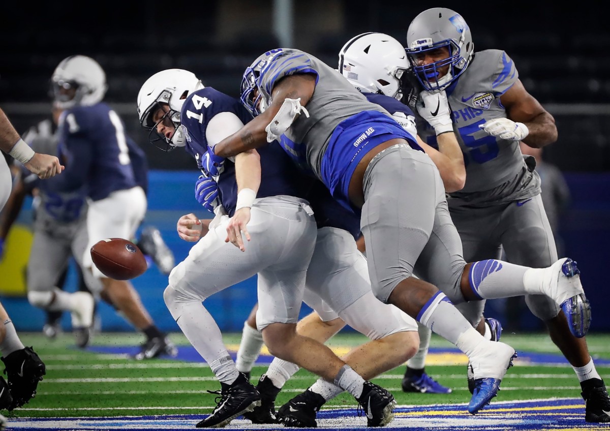 <strong>University of Memphis defender Morris Joseph (right) causes a fumble while sacking Penn State quarterback Sean Clifford (left) during action at the Cotton Bowl on Dec. 28, 2019, at AT&amp;T Stadium in Arlington, Texas.</strong> (Mark Weber/Daily Memphian)