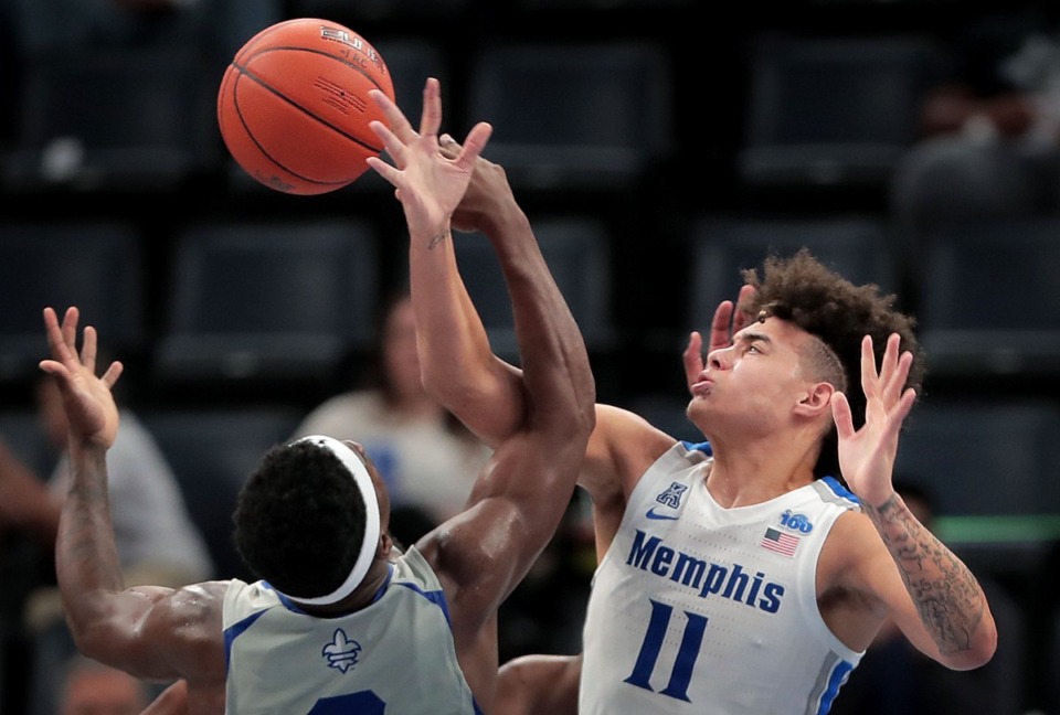 <strong>University of Memphis guard Lester Quinones (11) blocks a shot by the Privateers' Troy Green during the Tigers' game on Dec. 28, 2019, against New Orleans at the FedExForum. (</strong>Jim Weber/Daily Memphian)