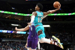 <strong>Memphis Grizzlies guard Ja Morant (12) goes up to shoot while defended by Charlotte Hornets center Willie Hernangomez (9) in the second half of an NBA basketball game Sun., Dec. 29, 2019, at FedExForum.</strong> (Karen Pulfer Focht/AP)