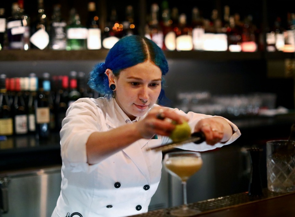 <strong>Bartender Rachel Barba puts the finishing touches on a handcrafted cocktail at the soft opening of Bishop in the newly remodeled Central Station lobby on Dec. 4, 2019.</strong> (Patrick Lantrip/Daily Memphian)