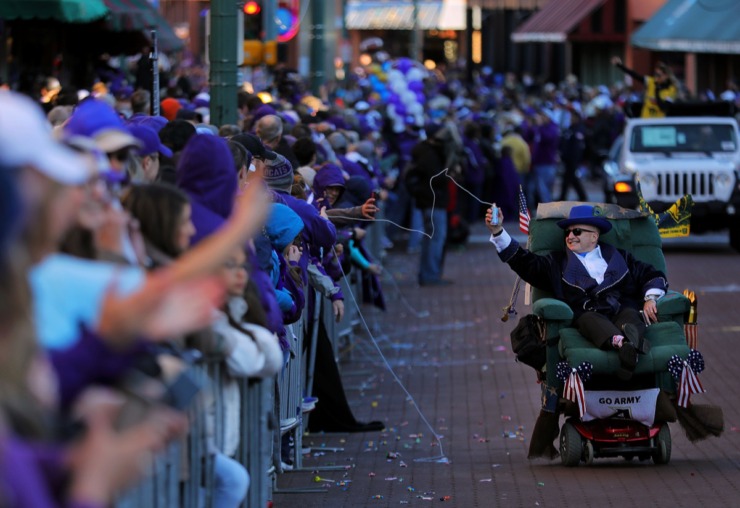 <strong>A man in a motorized recliner sprays the crowd during the AutoZone Liberty Bowl Parade Dec. 30, 2019.</strong> (Patrick Lantrip/Daily Memphian)