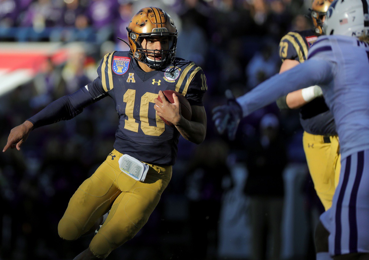 <strong>Navy quarterback Malcom Perry (10) scrambles past a Kansas State University defender during the first half of the AutoZone Liberty Bowl Dec. 31, 2019.</strong> (Patrick Lantrip/Daily Memphian)