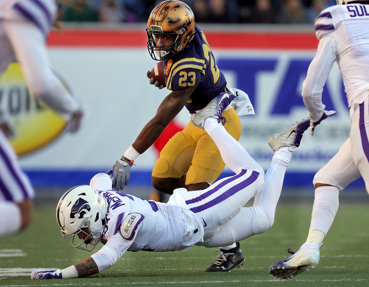 <strong>Navy running back Myles Fells (23) stiff-arms a Kansas State defender during the 61st AutoZone Liberty Bowl Dec. 31, 2019.</strong> (Patrick Lantrip/Daily Memphian)