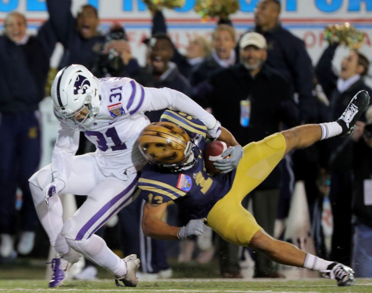 <strong>Navy wide receiver Chance Warren (13) makes a diving catch during the 61st AutoZone Liberty Bowl Dec. 31, 2019.</strong> (Patrick Lantrip/Daily Memphian)