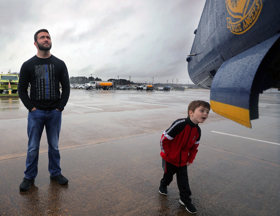 <strong>Connor Van Horn curiously inspects the nose of the Blue Angels jet parked at the Millington-Memphis Airport Jan. 2, 2020, while Alex Van Horn looks on. The Van Horns were one of several families who braved the rain for a sneak peak at the U.S. Navy fighter jet that will be at the Mid-South Airshow later this year.</strong> (Patrick Lantrip/Daily Memphian)