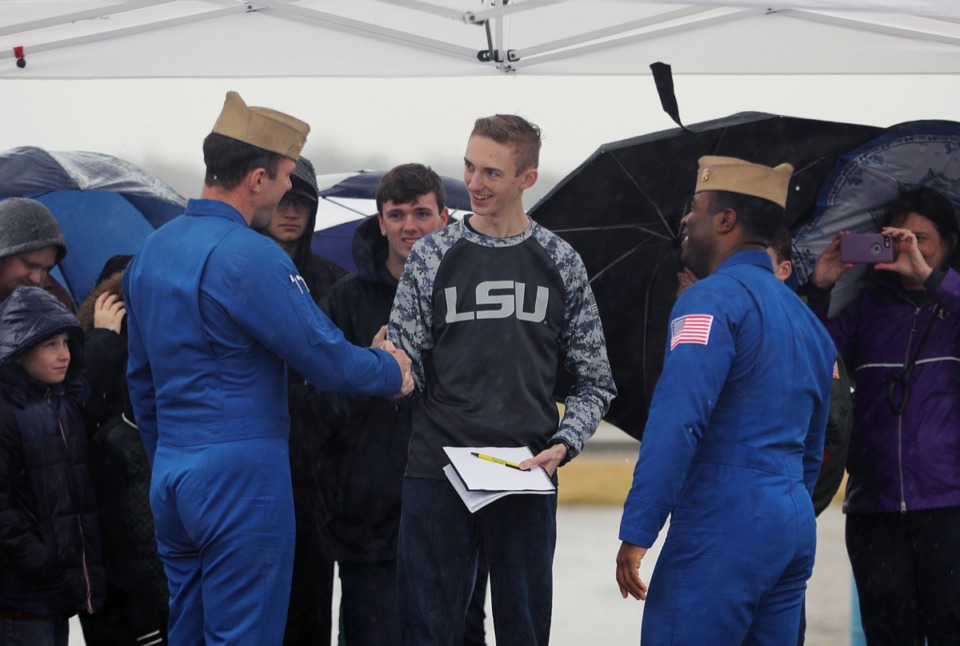 <strong>Sixteen-year-old Tommy Ducey (center) shakes hands with Lcdr. Adam Kerrick (left) and Lt. Julius Bratton (right) after getting the Blue Angels pilots' autographs at the Millington-Memphis Airport Jan. 2, 2020.</strong> (Patrick Lantrip/Daily Memphian)