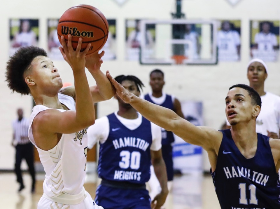 <strong>Arlington guard Philip Dotson (left) drives the lane against Hamilton Heights defender Andersson Garcia (right) during action Friday, Jan. 3, 2020, at Hoopfest.</strong> (Mark Weber/Daily Memphian)
