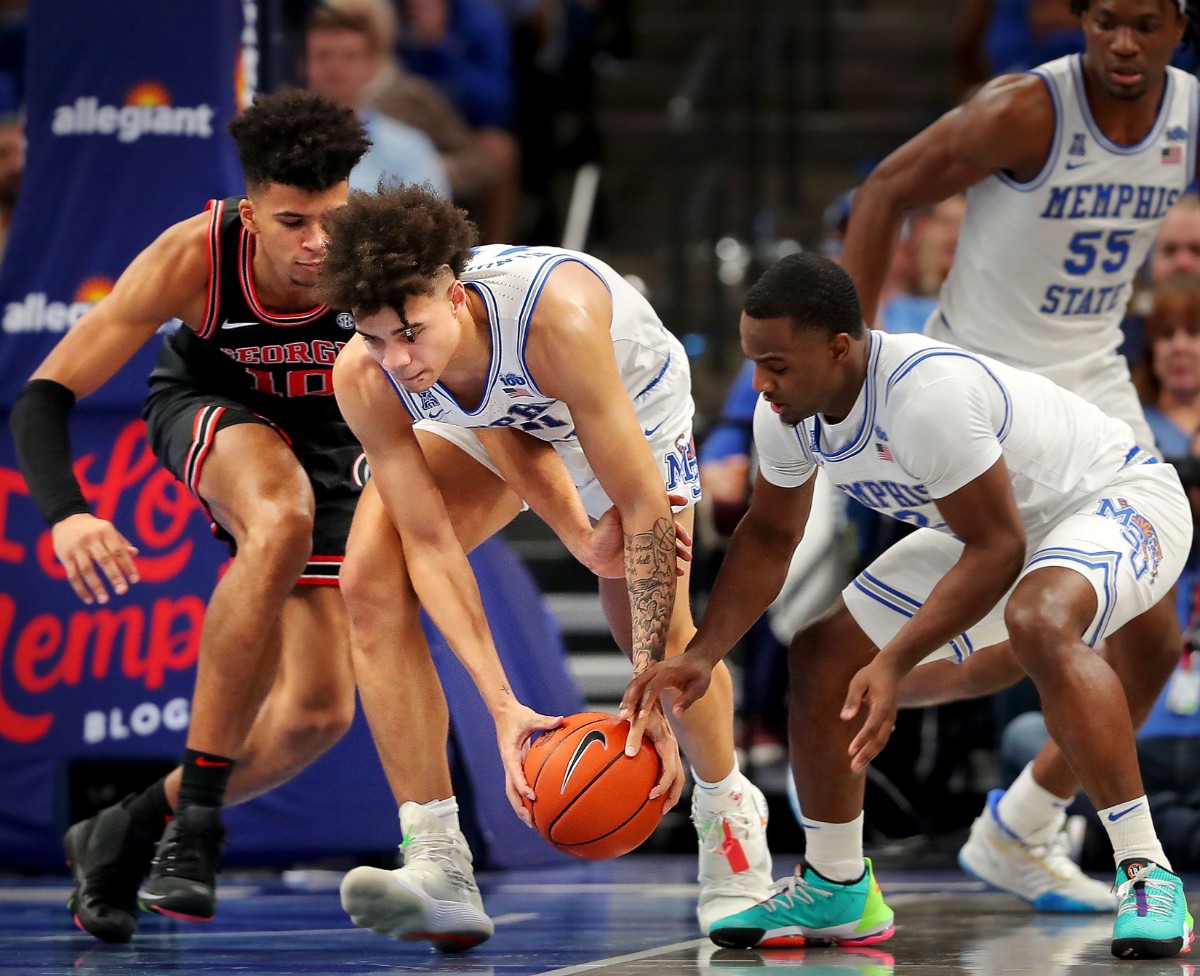 <strong>University of Memphis guard Lester Quinones (center) snags a loose ball from the Bulldogs' Toumani Camara during the Tigers' game on Jan. 4, 2020, against Georgia at the FedExForum.</strong> (Jim Weber/Daily Memphian)